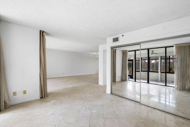 empty room featuring a textured ceiling