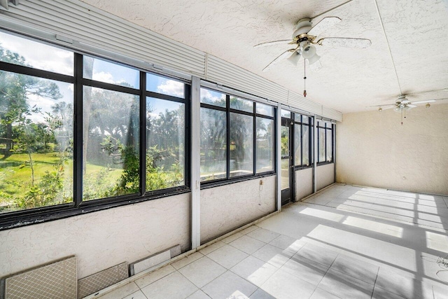 unfurnished sunroom featuring ceiling fan