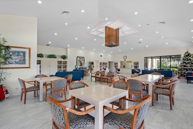 dining area featuring high vaulted ceiling