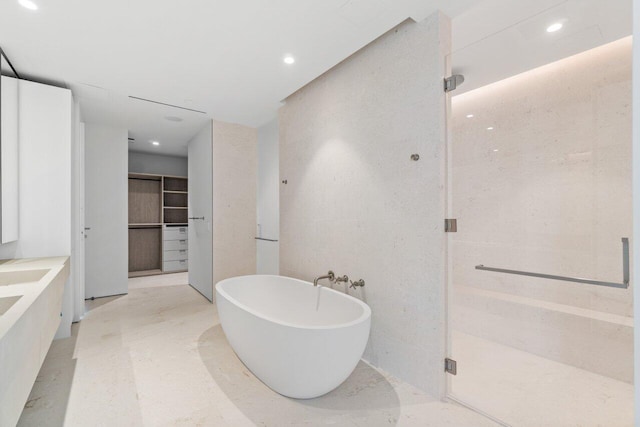 bathroom featuring vanity and shower with separate bathtub