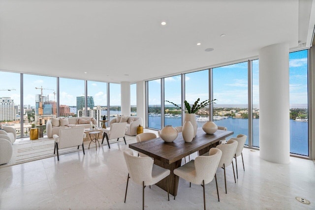 dining room with a water view and floor to ceiling windows