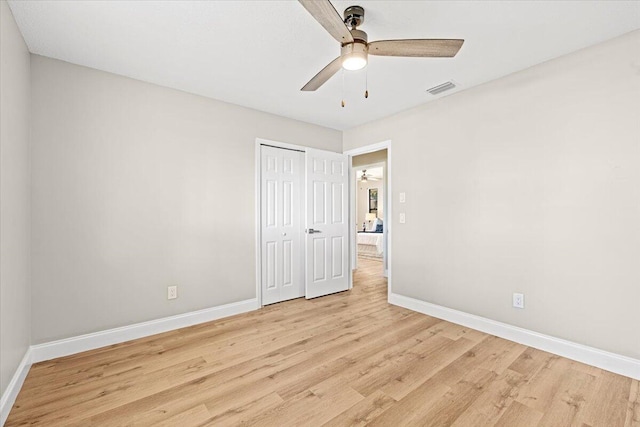 spare room with ceiling fan and light wood-type flooring