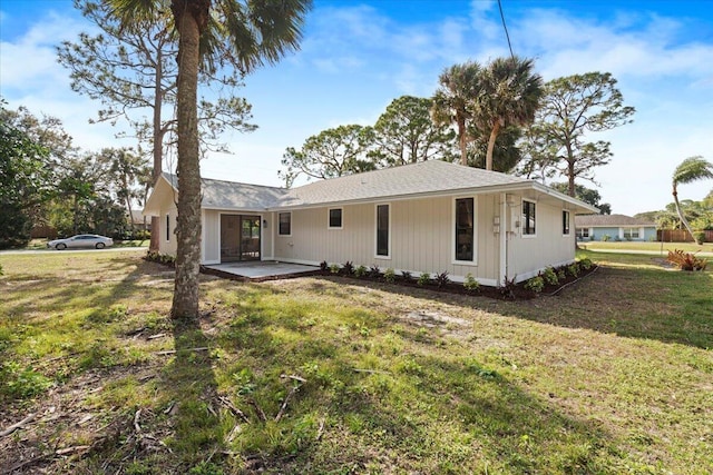 back of house featuring a yard and a patio