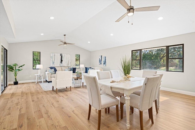 dining space featuring ceiling fan, a healthy amount of sunlight, lofted ceiling, and light wood-type flooring