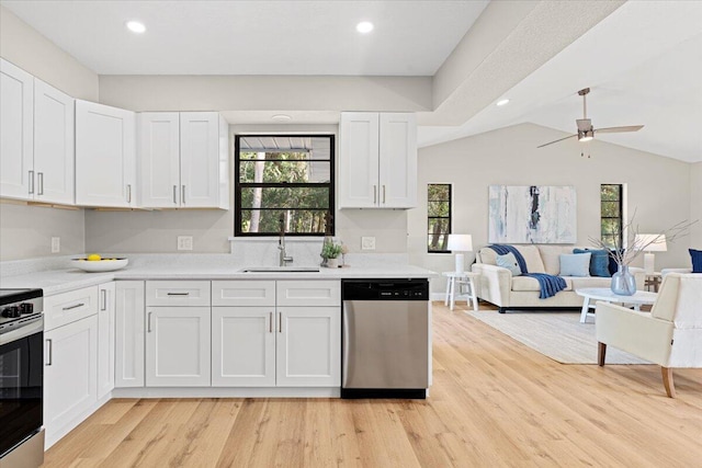 kitchen with white cabinets, range, stainless steel dishwasher, and sink