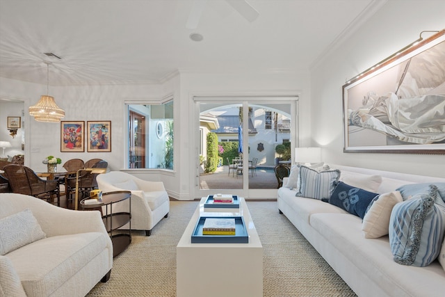 living room featuring an inviting chandelier and ornamental molding