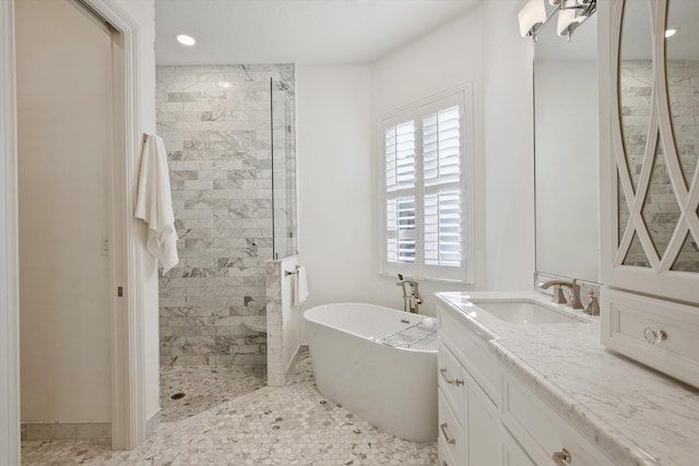 bathroom featuring vanity and plus walk in shower