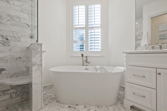 bathroom with vanity and a washtub