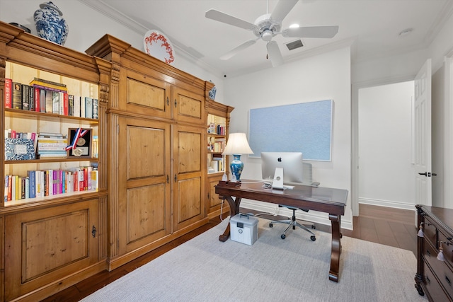 office area featuring ceiling fan, dark wood-type flooring, and ornamental molding