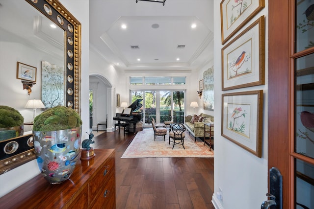 interior space with a high ceiling, ornamental molding, and dark hardwood / wood-style floors