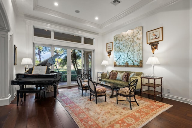 sitting room featuring crown molding, hardwood / wood-style floors, and a tray ceiling