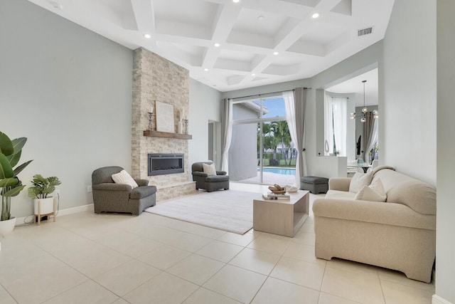 living room with a fireplace, coffered ceiling, light tile patterned floors, a notable chandelier, and beam ceiling