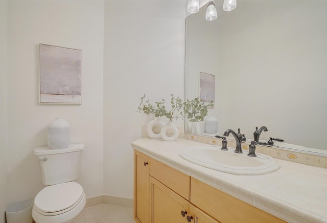 bathroom featuring vanity, tile patterned floors, and toilet