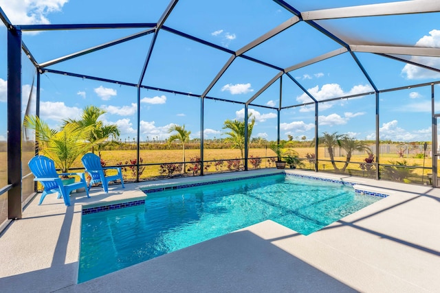 view of pool featuring a rural view, a lanai, and a patio