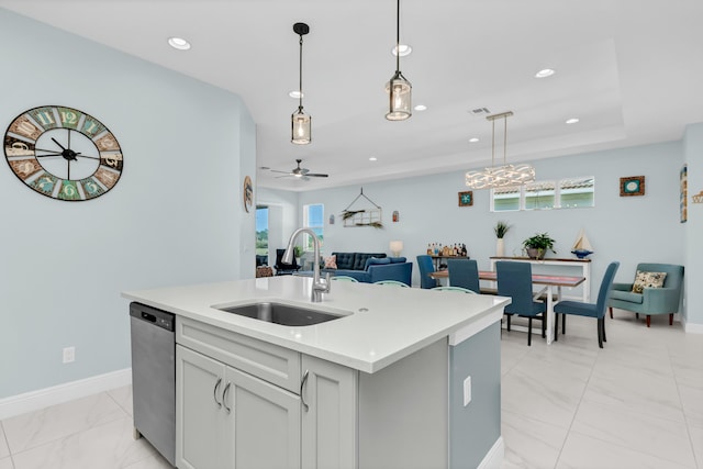 kitchen with sink, ceiling fan, an island with sink, decorative light fixtures, and stainless steel dishwasher