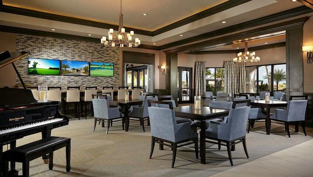 dining space with a raised ceiling, crown molding, and a notable chandelier