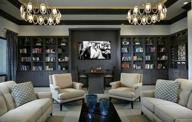 sitting room featuring built in shelves, ornamental molding, and a chandelier