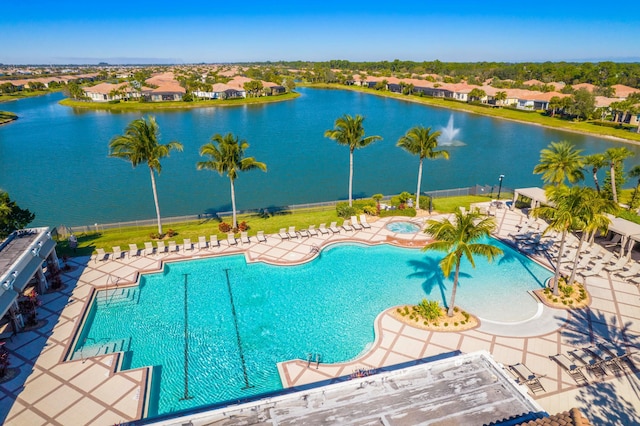 view of swimming pool with a water view and a patio area