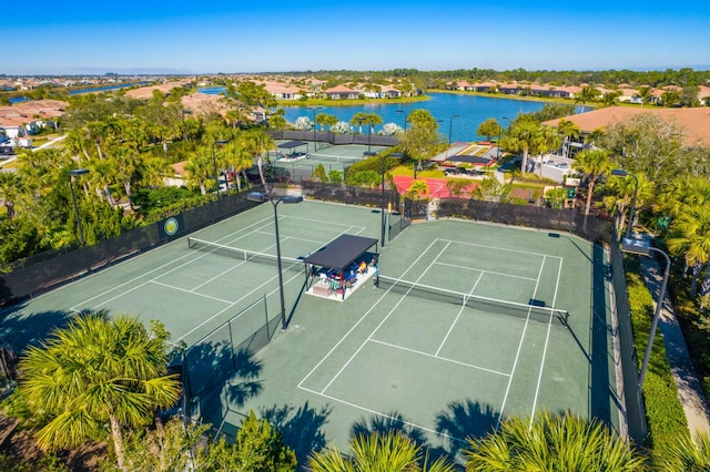 view of sport court with a water view