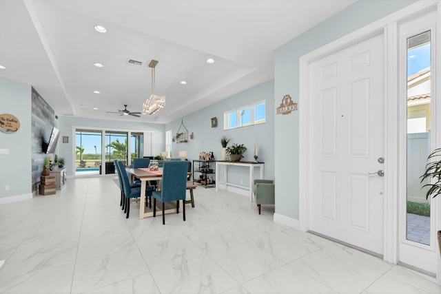 dining area with a tray ceiling