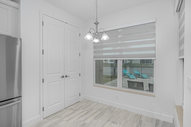 unfurnished dining area with an inviting chandelier