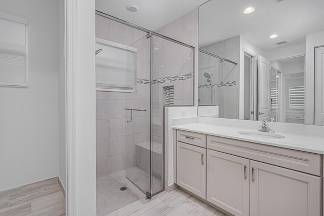 bathroom with an enclosed shower and vanity