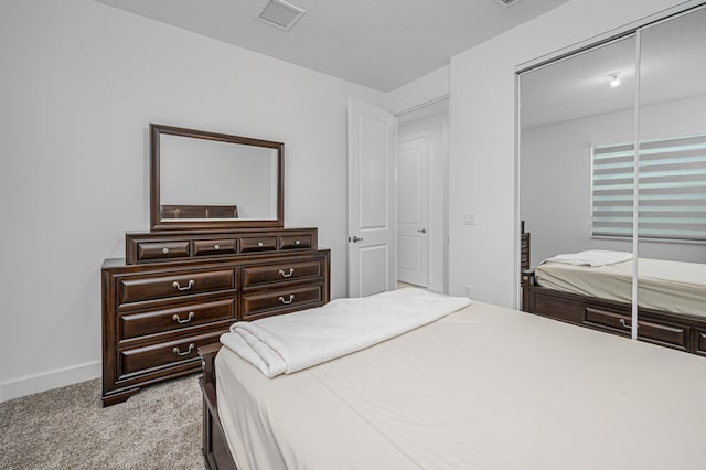 bedroom featuring light carpet and a closet