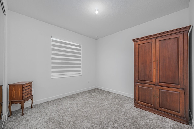 unfurnished bedroom featuring light carpet