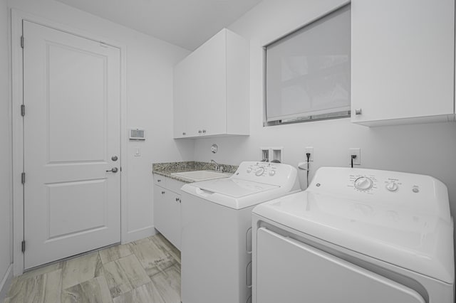 laundry room with sink, cabinets, and washing machine and clothes dryer