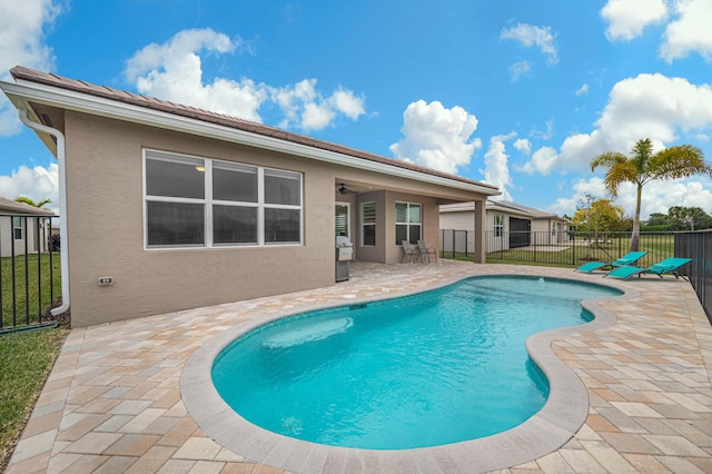 view of pool featuring area for grilling and a patio