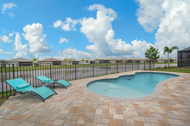 view of pool featuring a patio and a water view