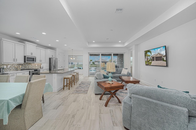 living room with a tray ceiling