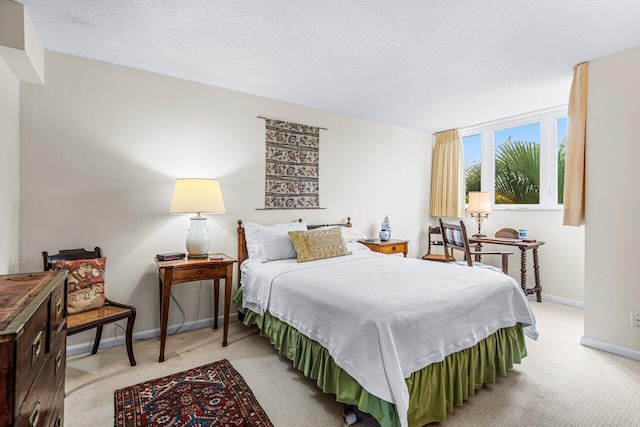 carpeted bedroom with a textured ceiling