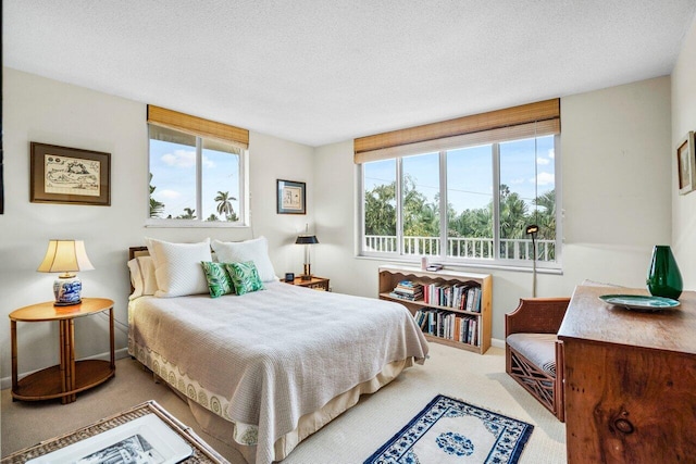 carpeted bedroom with a textured ceiling