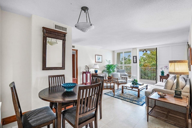 dining space with a textured ceiling