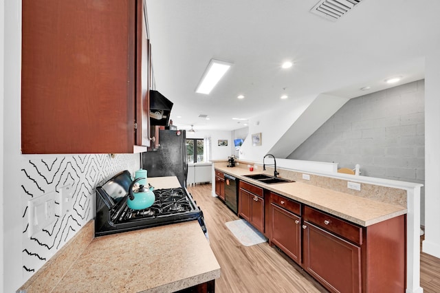 kitchen featuring sink, black appliances, and light wood-type flooring