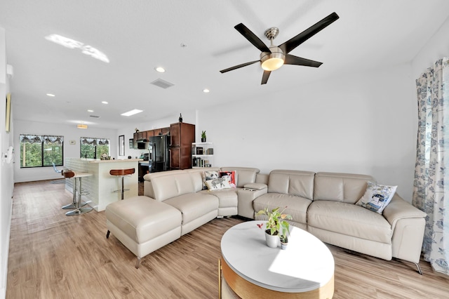 living room with ceiling fan and light hardwood / wood-style floors