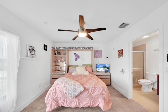 carpeted bedroom with ceiling fan and ensuite bath