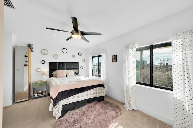 bedroom with ceiling fan and light carpet