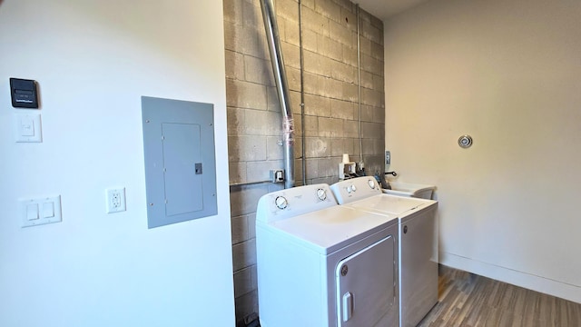 washroom with washer and dryer, sink, electric panel, and dark hardwood / wood-style floors