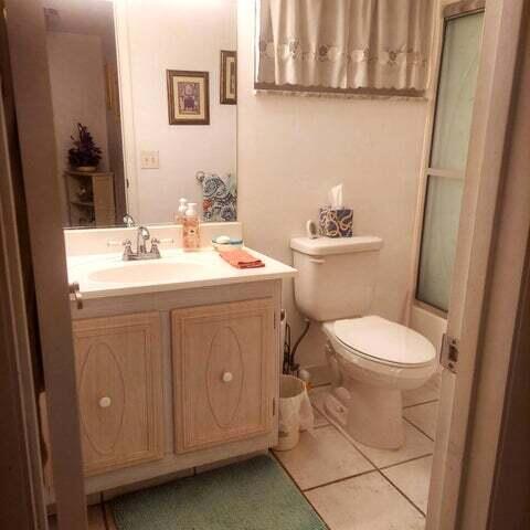 full bathroom featuring tile patterned flooring, vanity, toilet, and enclosed tub / shower combo