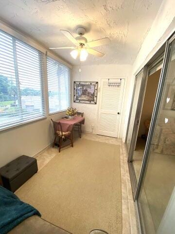 living area with ceiling fan