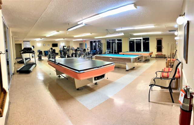 playroom with a textured ceiling and billiards