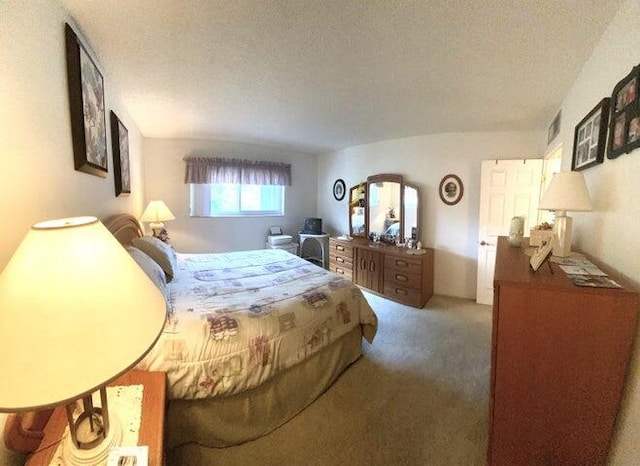 carpeted bedroom featuring a textured ceiling