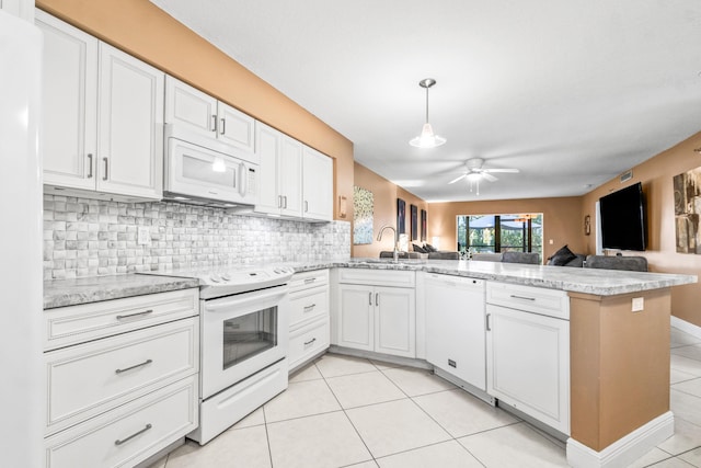 kitchen with kitchen peninsula, white cabinetry, and white appliances