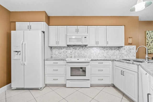 kitchen with white cabinets, light tile patterned flooring, white appliances, and sink