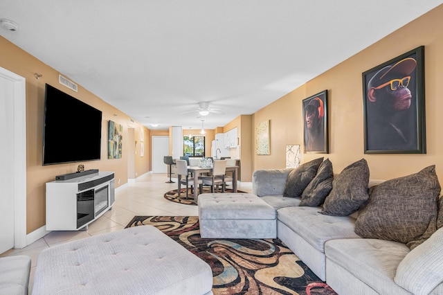 tiled living room featuring ceiling fan