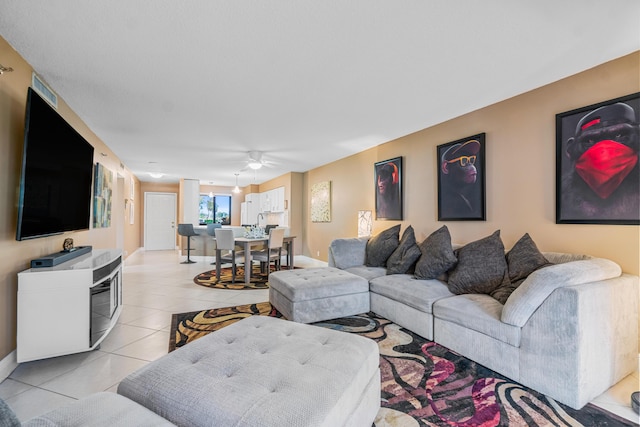 tiled living room with ceiling fan