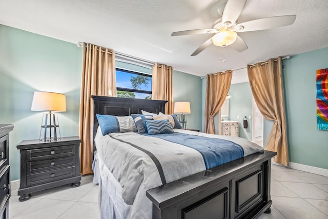 tiled bedroom with ceiling fan and a textured ceiling