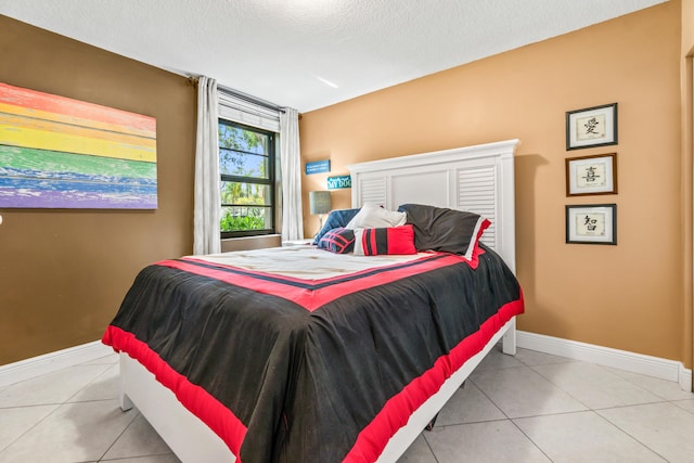 bedroom with light tile patterned floors and a textured ceiling